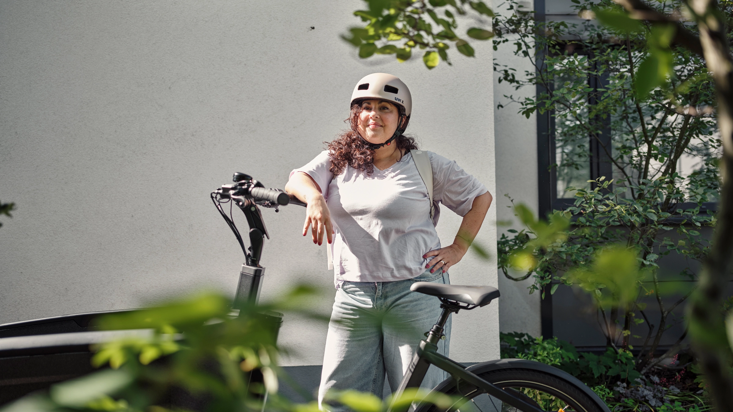 Professional leaning on a company bicycle in a relaxed work setting